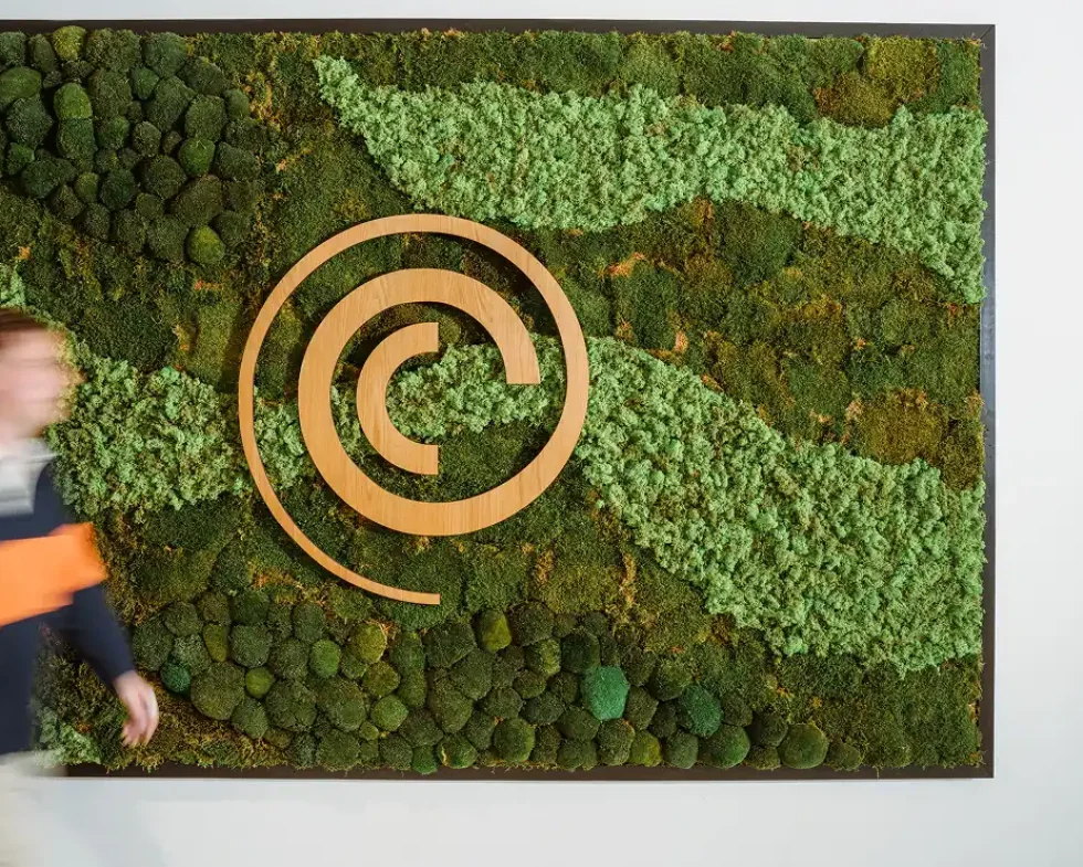 Decorative green moss wall featuring the Cyso logo